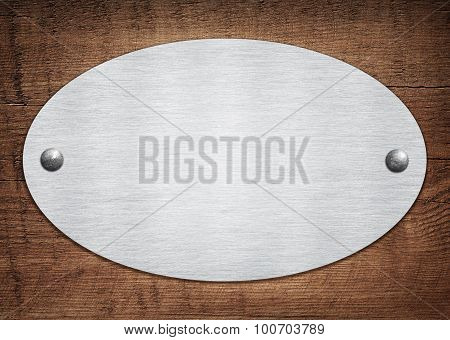 Composition of metal aluminum plaque, name plate on wooden plank
