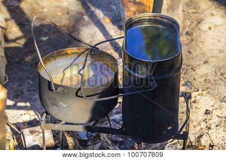 Background Two pot with water heated on the fire during a camping trip