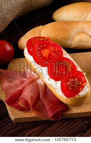 Smoked Ham And Baguette On Wooden Board