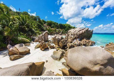 Beautifully shaped granite boulders and a perfect white sand at the Anse Patates beach, La Digue island, Seychelles