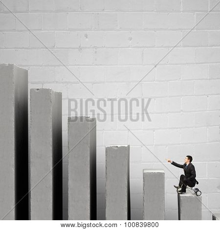 Young funny businessman riding three wheeled bicycle