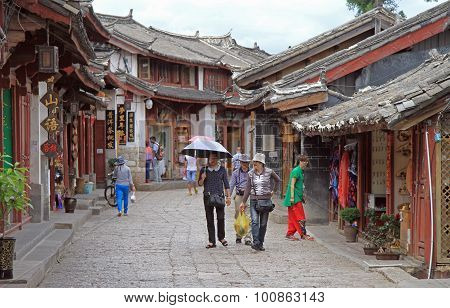people are walking on the street in Lijiang, China