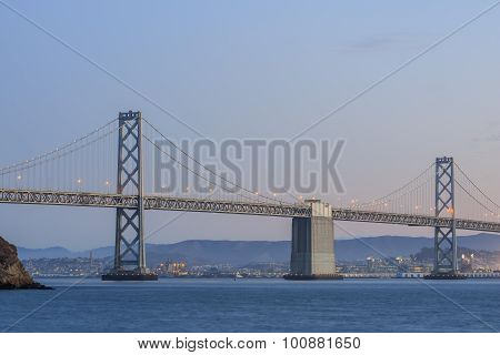 San Francisco – Oakland Bay Bridge With Lights At Sunset Time