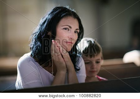Woman with her son praying