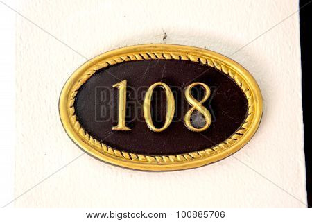 the room number 108 written on a sign