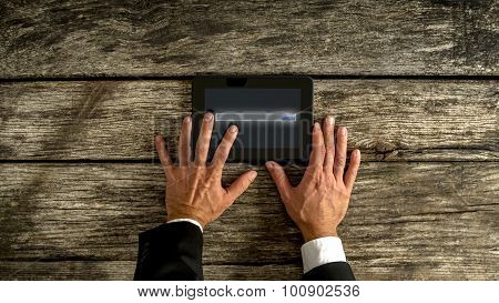 Businessman Hand Holding Tablet On The Table