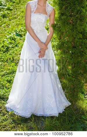 Bride, row of bridesmaids with bouquets at big wedding ceremony.