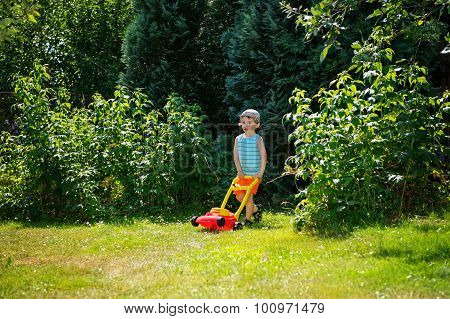 Happy Small Boy Help With Gardening With His Lawn Mower