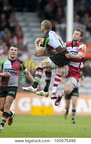 TWICKENHAM, ENGLAND. 17 SEPTEMBER 2011. Harlequins Mike Brown, is tackled in the air by Gloucester's Henry Trinder, during the premiership rugby union match between Harlequins and Gloucester