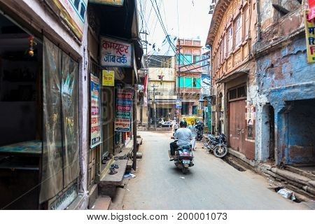 JODHPUR RAJASTHAN INDIA - MARCH 04 2016: Horizontal picture of old houses and stores in a normal street of old Jodhpur the blue city of Rajasthan in India.