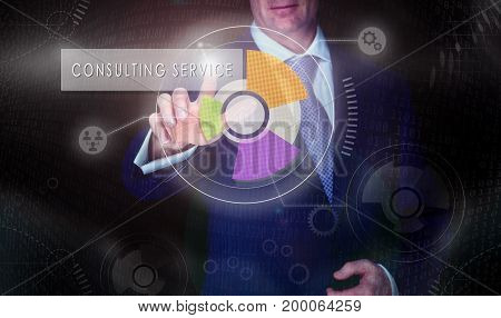 A Businessman Selecting A Consulting Service Button On A Computerised Display Screen.