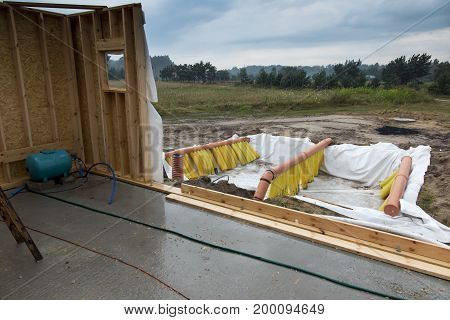 Building a ground heat exchanger to heat up the air in winter and cool down in summer