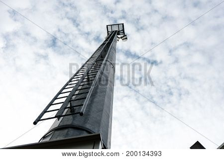 stadium light pole with cloudy sky view from floor