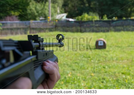 A Man Shoots A Target From A Pneumatic Gun. A View From Behind The Shoulder