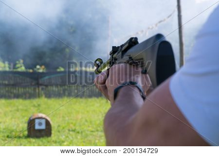 A Man Shoots A Target From A Pneumatic Gun. A View From Behind The Shoulder