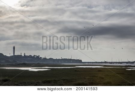 El Rompido lighthouse and marina at sunrise from marshlands Huelva Spain