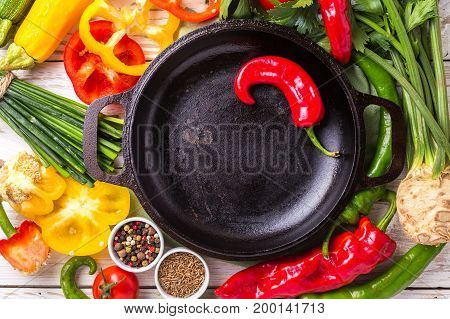 Various Vegetables Ingredients On Wooden Table Around Frying Pan