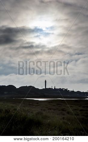 El Rompido lighthouse and marina at sunrise from marshlands Huelva Spain