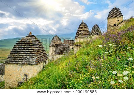 City of the dead or a necropolis near the village of Dargavs in Alania. Old cemetery with traditional crypts and tombs in the mountains