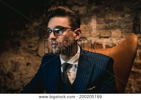 Sharp dressed dandy in a chair