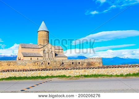 Panorama view of Alaverdi orthodox monastery in Kakhetia region in Georgia and snow peaks of Caucasus mountains