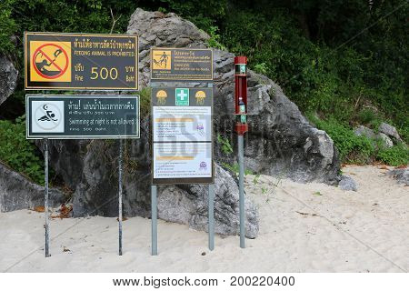 Vinegar with jellyfish warning signs on the beach in Thailand.