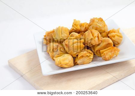 Deep fried wonton or fried dumplings cuisine on white plate