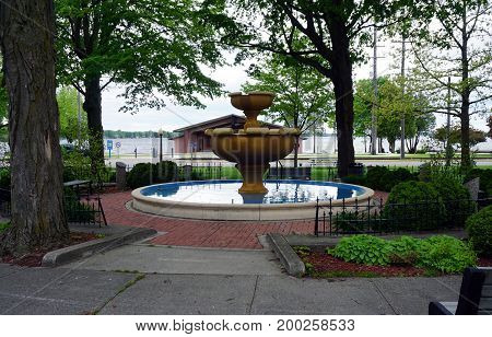 CADILLAC, MICHIGAN / UNITED STATES - MAY 31, 2017: 
The Kris Eggle Memorial Fountain stands in the Cadillac Commons City Park, between downtown Cadillac and Lake Cadillac.