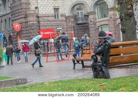 Kiev Ukraine - October 08 2016: Homeless sits on a bench in the city center