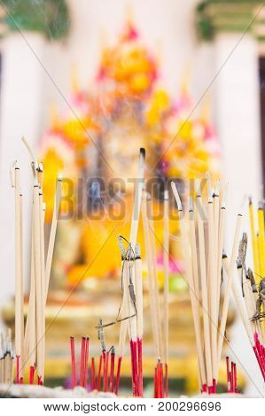 Incense in a pot at the Buddha image. Faith faith blessings fortune in Buddhism.