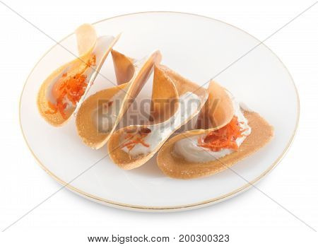 Thai Traditional Snack and Dessert Plate of Crispy Pancake or Crepes Filled with Sweet Coconut Cream and Salted Shredded Coconut Isolated on White Background.