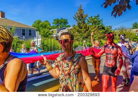 Provincetown, Massachusetts US - August 17, 2017 People walking in the 39th Annual Provincetown Carnival Gods and Goddess Parade on Commercial Street