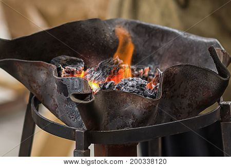 Fireplace horn in forges firewood iron hand work traditional method background
