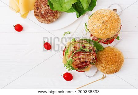 Big Sandwich - Hamburger Burger With Beef, Cheese, Tomato, Cucumber And Fried Bacon. Flat Lay. Top V