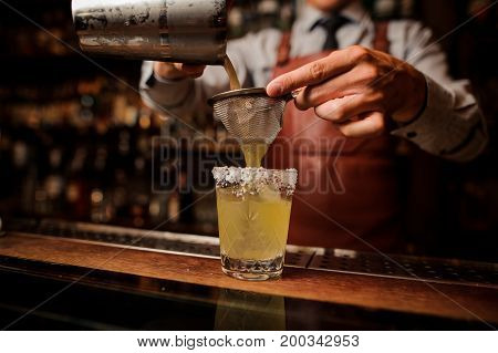 Delicious cocktail based on tequila with bacon and salt close up