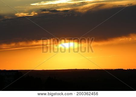 A spectacular sunset photographed from above a hill