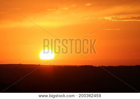A spectacular sunset photographed from above a hill