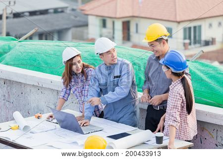 Harmonious Engineer And Technician Team Dicussing In Building Construction Site. Teamwork Collaborat