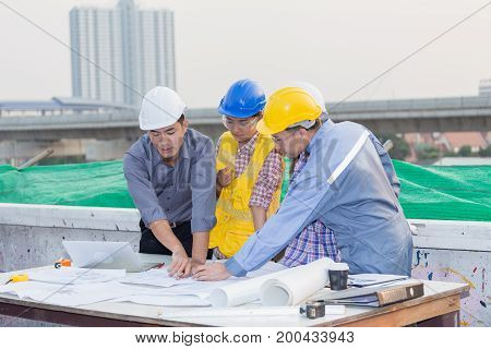 Harmonious Engineer And Technician Team Dicussing In Building Construction Site. Teamwork Collaborat