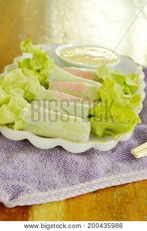 imitation crab stick and green oak wrapped flour paste dipping cream sauce on plate