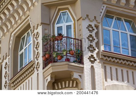 Flowers on the balcony of the building in the classical style. Architecture