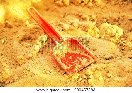 Golden Shining Sand And Plastic Sovochke. Symbol Of Gold Mining. The Gold-bearing Rock. Also A Symbo