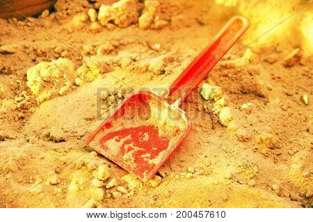 Golden Shining Sand And Plastic Scoop. Symbol Of Gold Mining. The Gold-bearing Rock. Also A Symbol O