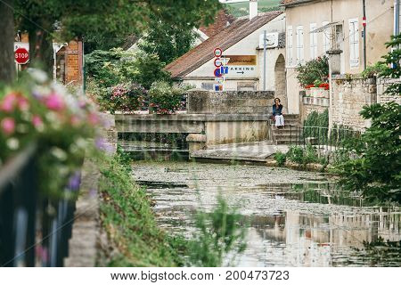 A park in the city of Chablis lots of greenery and a view of the beautiful lake in flowers. July 23 2017