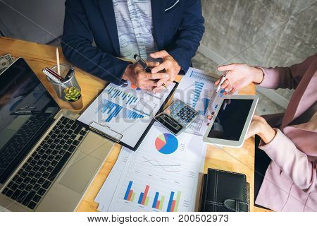 Business team meeting working with new startup project discussion and analysis data the charts and graphs. Digital tablet calculator laptop computer using Business finances and accounting concept.