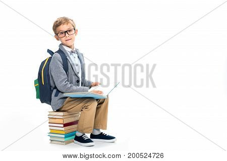 Schoolboy Sittting On Stack Of Books And Reading