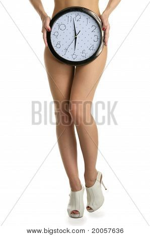 Women's legs and round clock