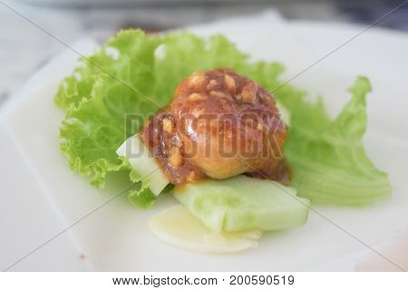 Nham nueng is vietnamese food consist of many vegetables and meatball wrapped in noodle with sauce.
