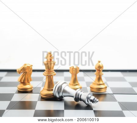 Chess board game gold player killed silver king for business competition metaphor winner and loser concept shallow depth of field with copy space select focus on golden chess