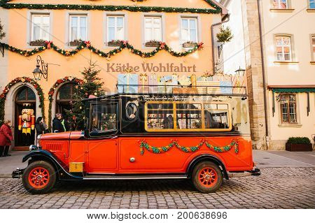 Rothenburg ob der Tauber, December 30, 2017: Decorated in a Christmas style car next to a toy store. Kathe Wohlfahrt Christmas decorations and toy shop. A popular toy store in Germany.